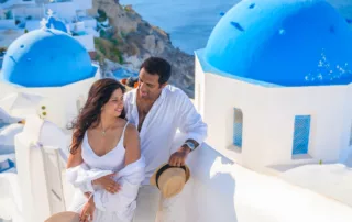 casual suits are white for a vow renewal on the Hill of Santorini, Greek island