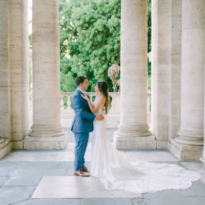 The couple in between the columns of the Vatican in Rome