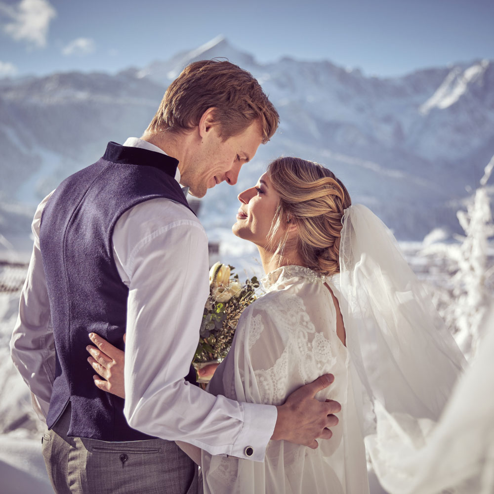 Facing each other, after a kiss of the wedding ceremony, in Austrian Muntain