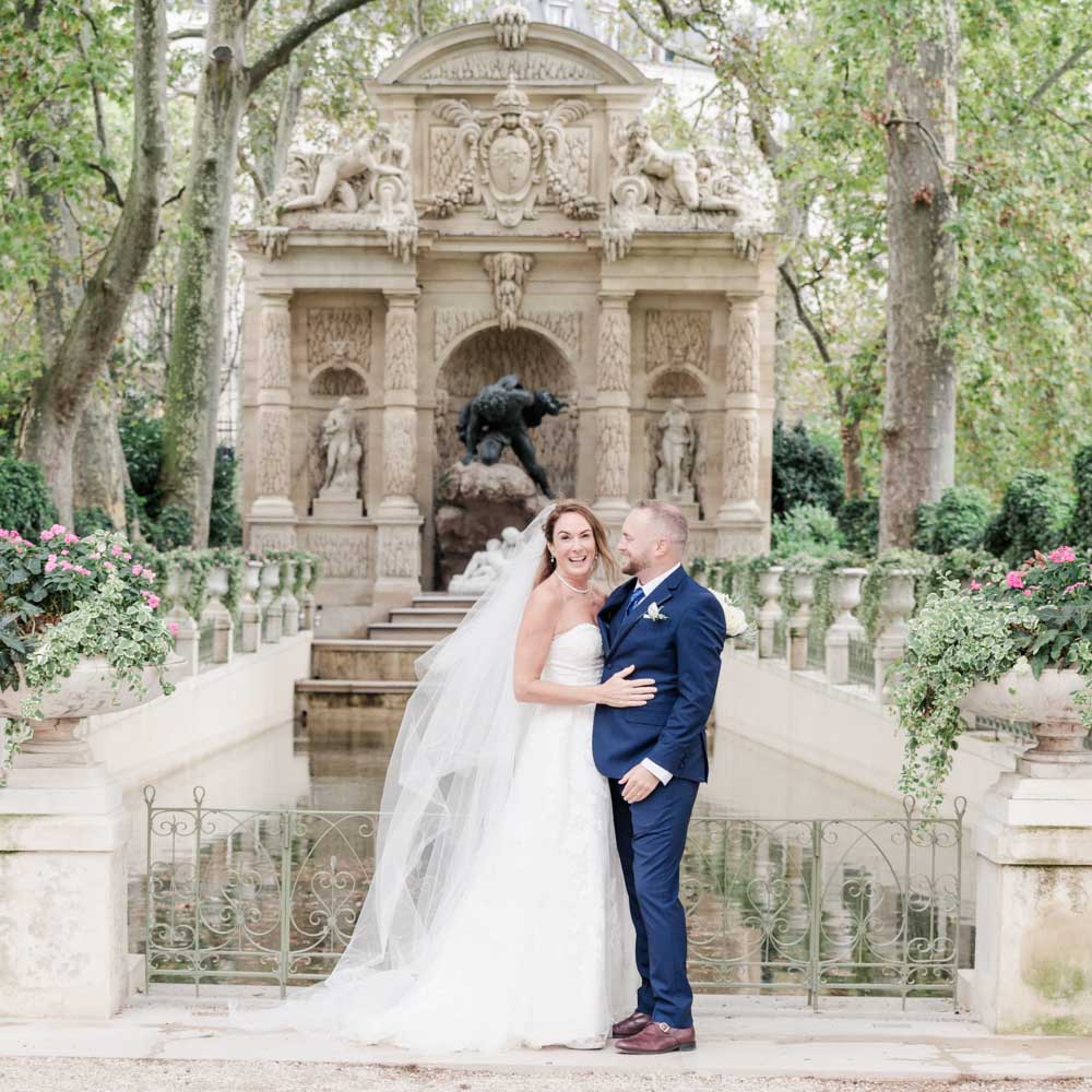 the couple in front of the Medicis fountain, bride is smiling