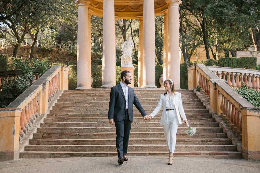 the couple walking hand to hand and looking to each other