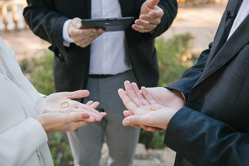 the celebrant explains the idea of to get married for the couple, zoom on the hands