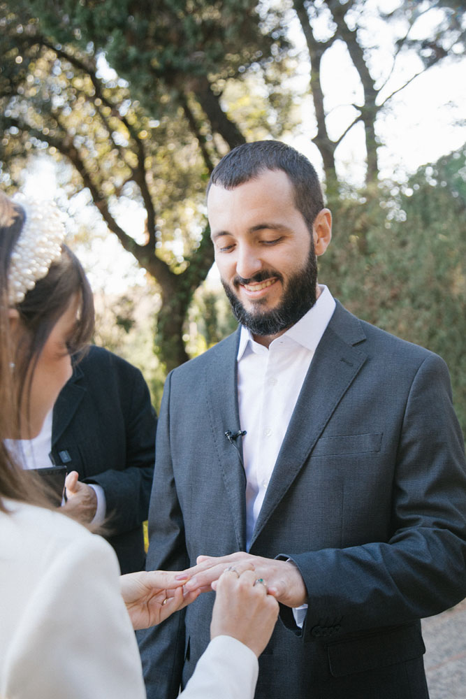 The bride slides the ring to the groom after saying 