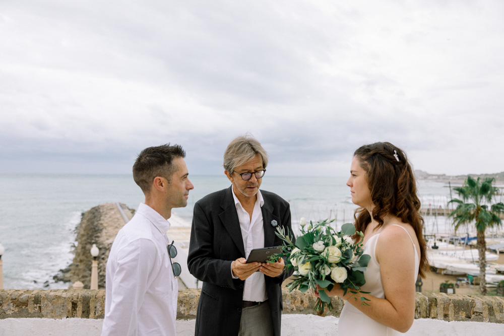 The celebrant reads the text for the ceremony, the couple is facing each other