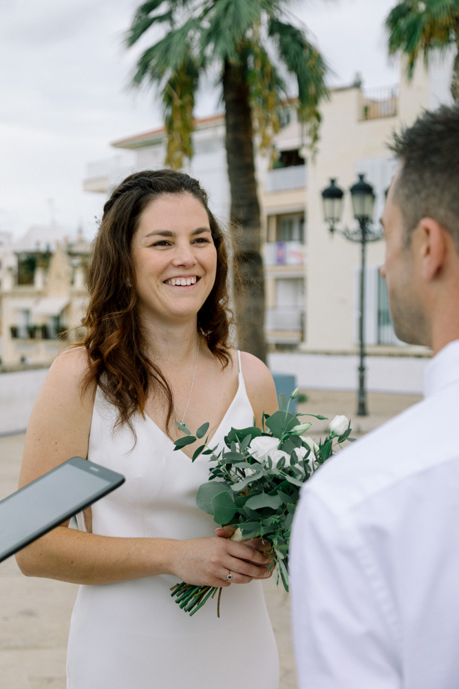 the bride smiles during the vows said by the groom