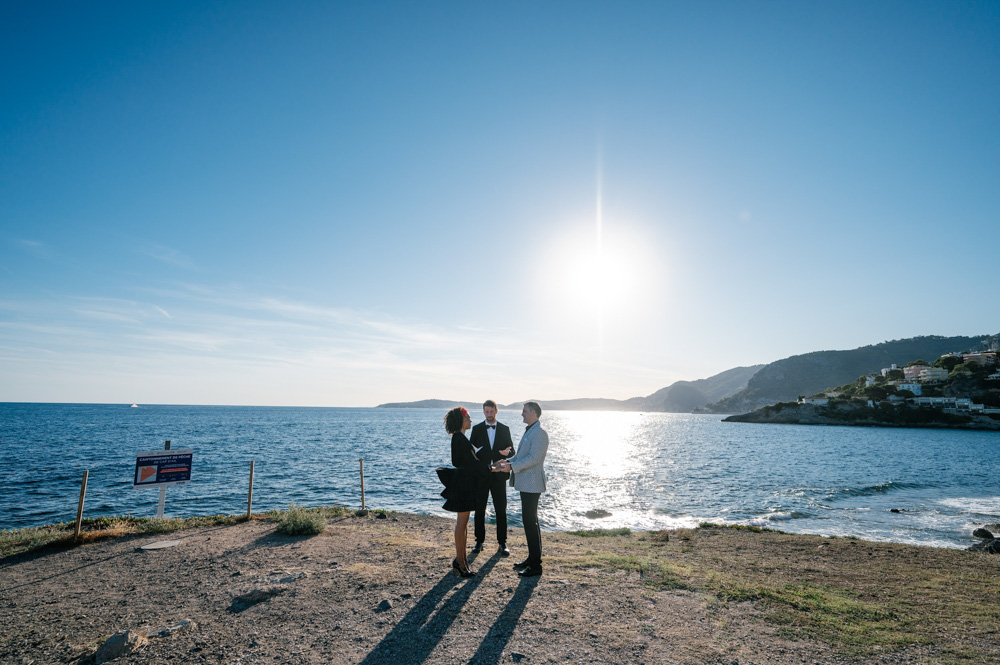 The couple and celebrant close to the see in a very intimate location.