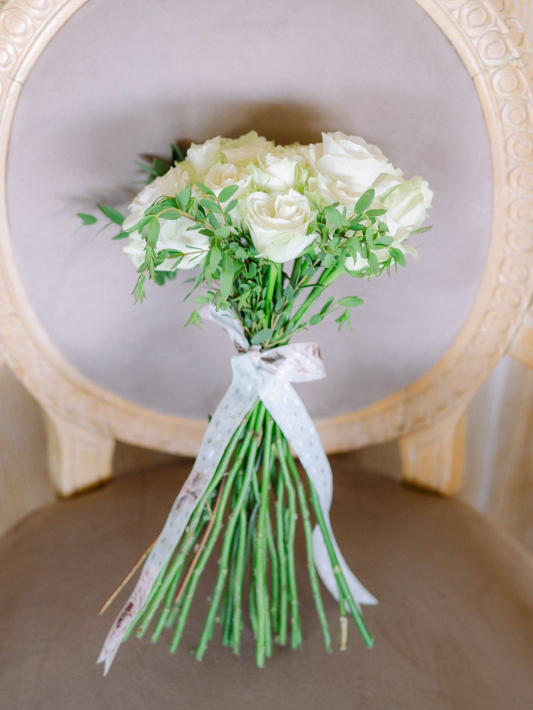 The bouquet of the bride on a vintage chair of 18th century of the hotel