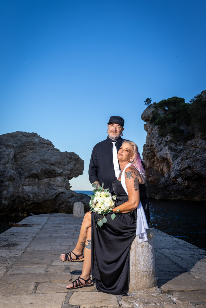 The bride and groom posing on a pier after the photo tour in Dubrovnik