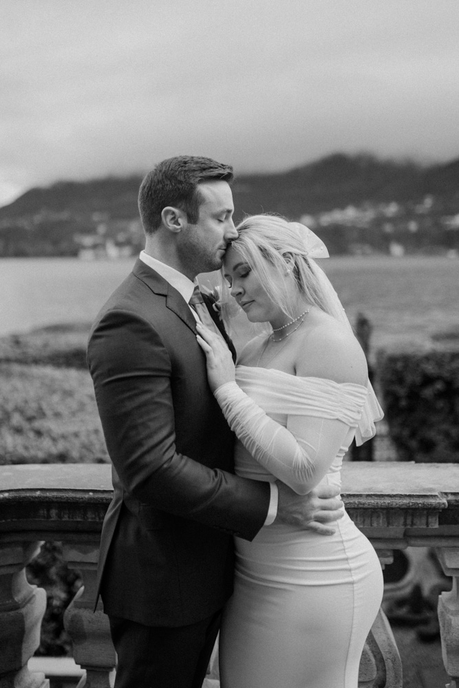 A black and white picture for the couple , a moment of love with the bride against her husband