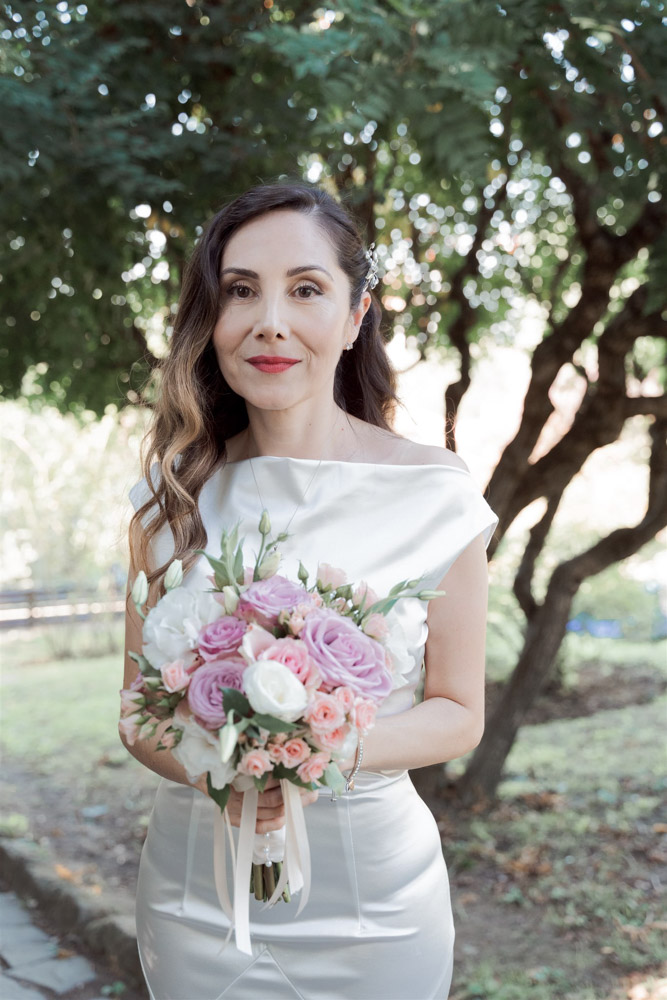 the satin dress of the bride and her bouquet