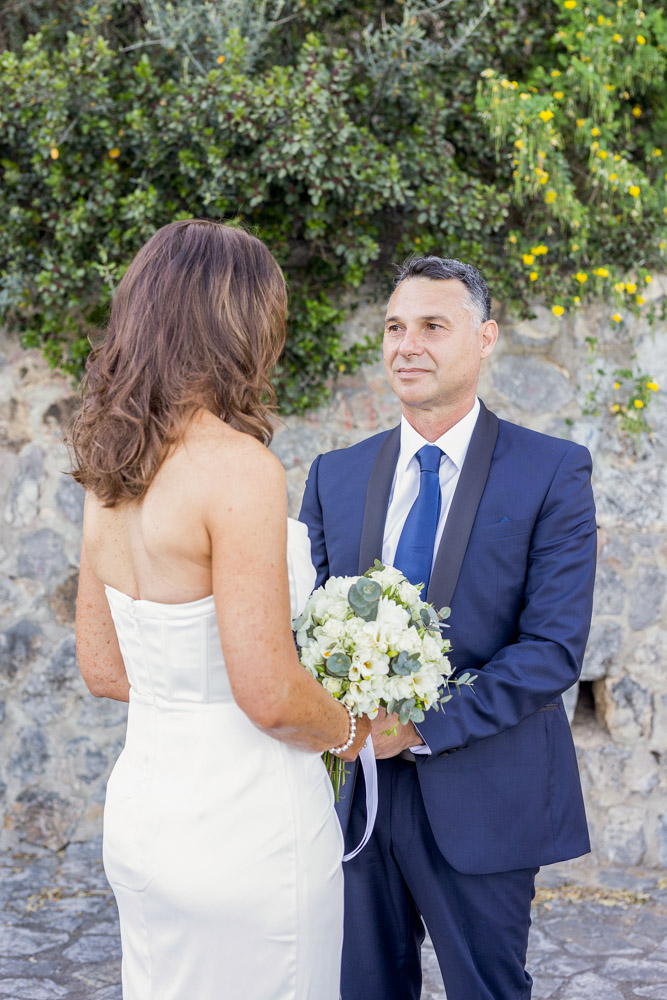 the groom looks to the bride during the exchange of vows