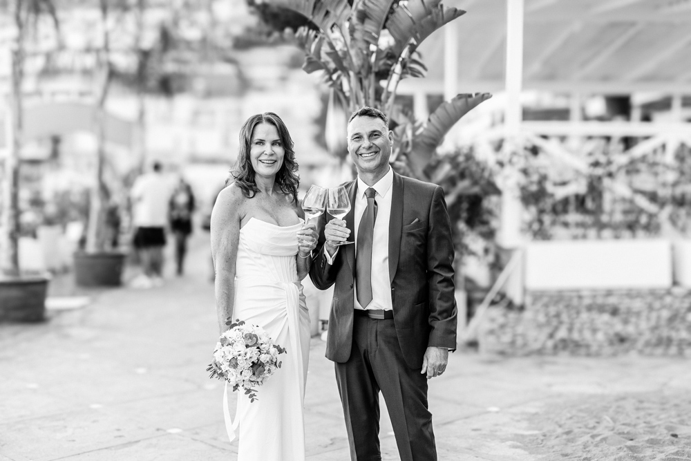 a black and white picture when the couple drink a cup of champagne on a terrace in the Positano village