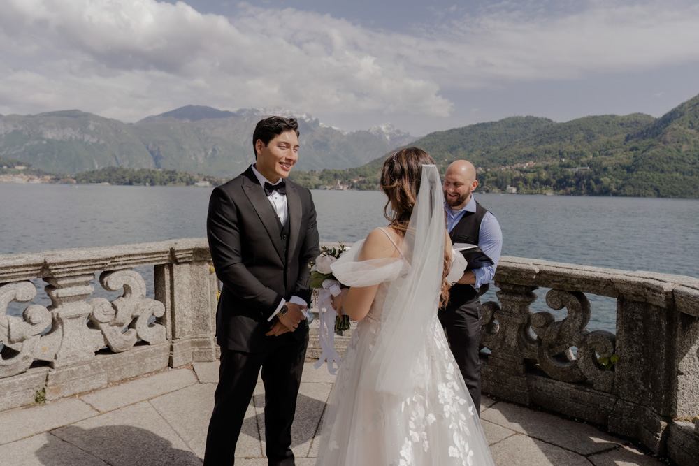 bride and groom at the balcony, the como lake in the back ground