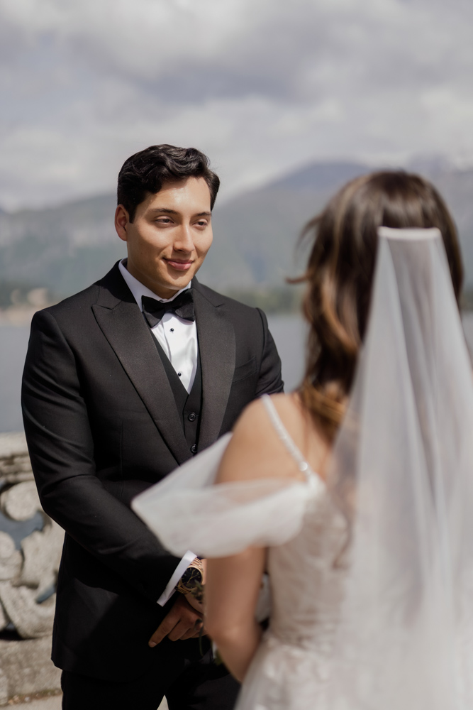 the groom looks to the bride smiling during the speech of the celebrant