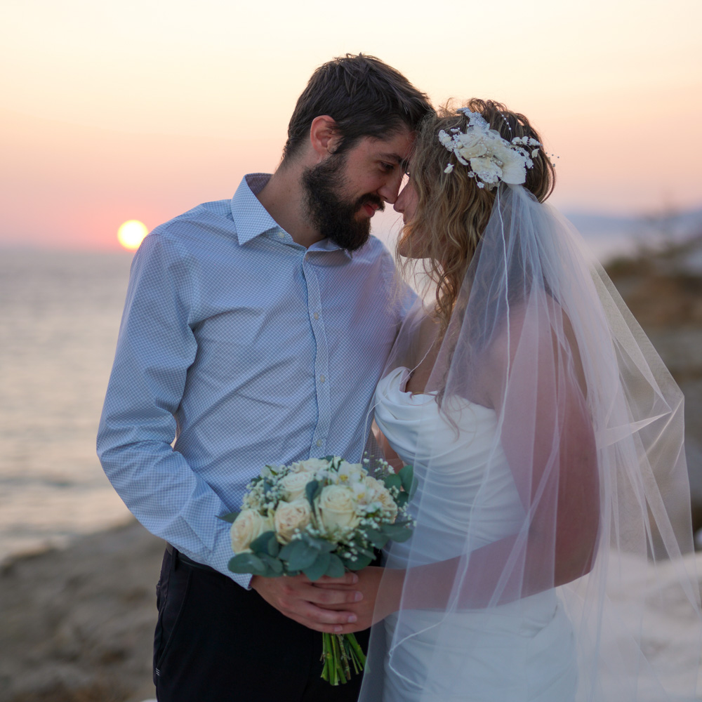 Sunset time for this couple in Mykonos, posing forehead against forehead