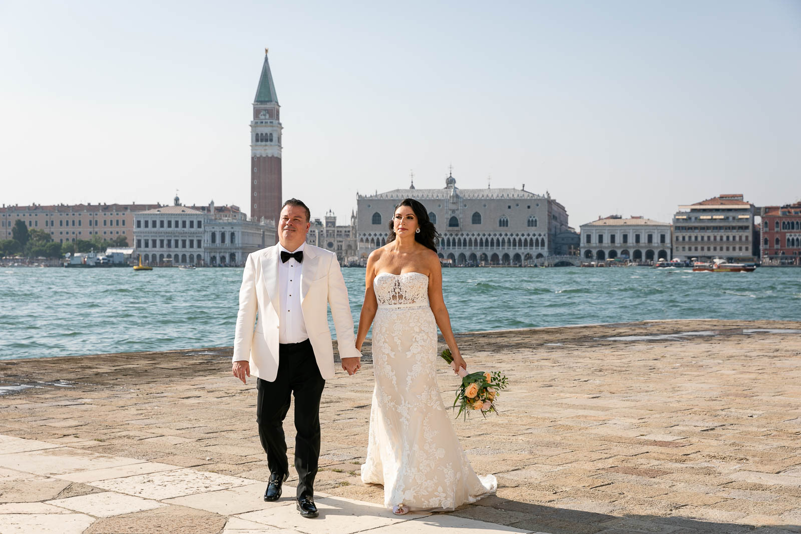 The couple walking hand to hand, after the elopement ceremony in Venice