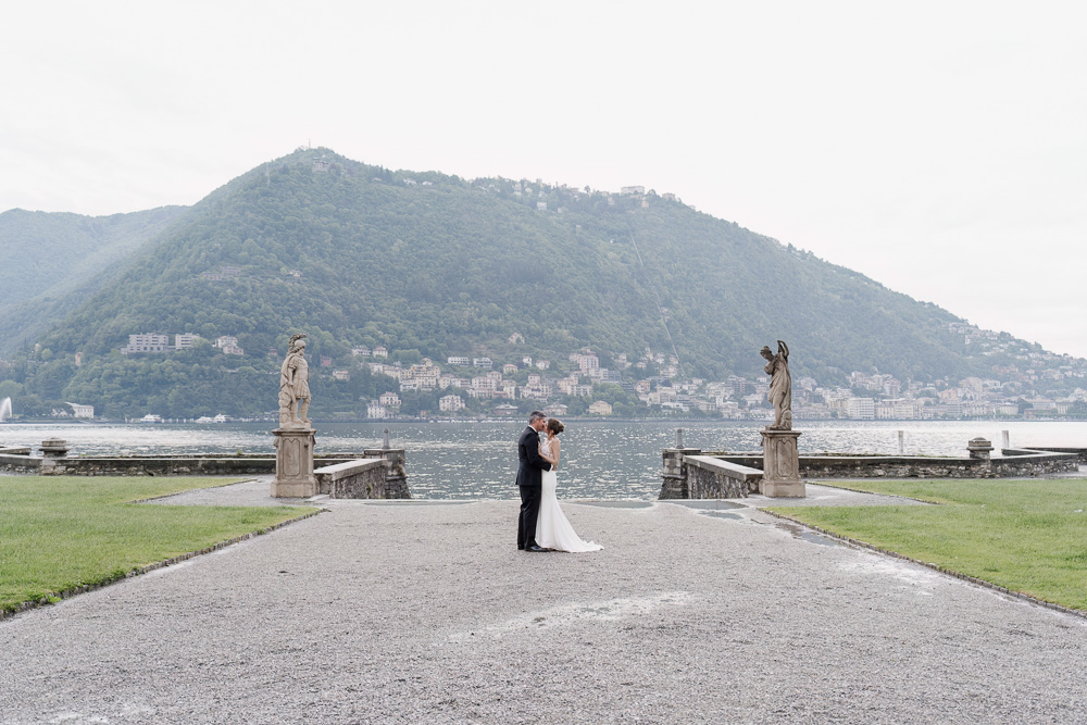 A great view with the lake in the background, the couple stands nearby the river