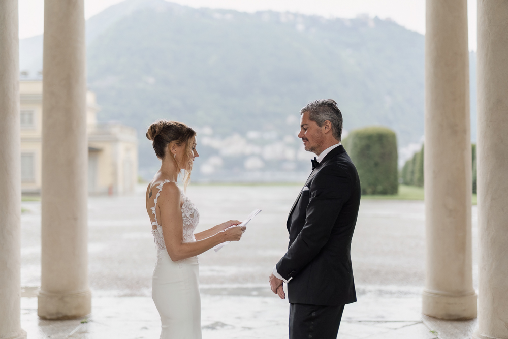 The bride reads his vows with a paper note