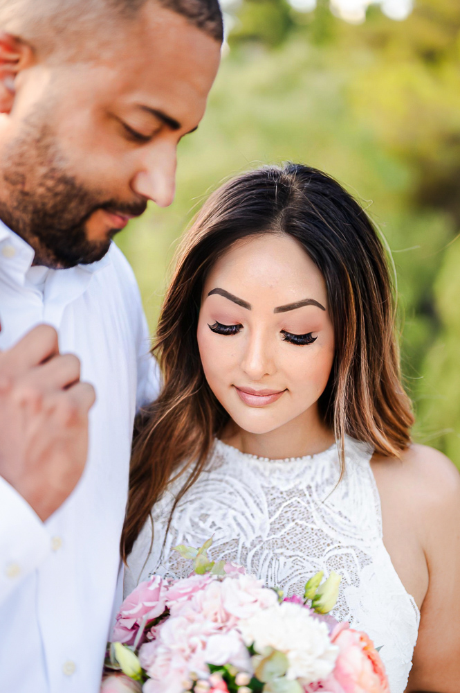 The couple looking to the bouquet