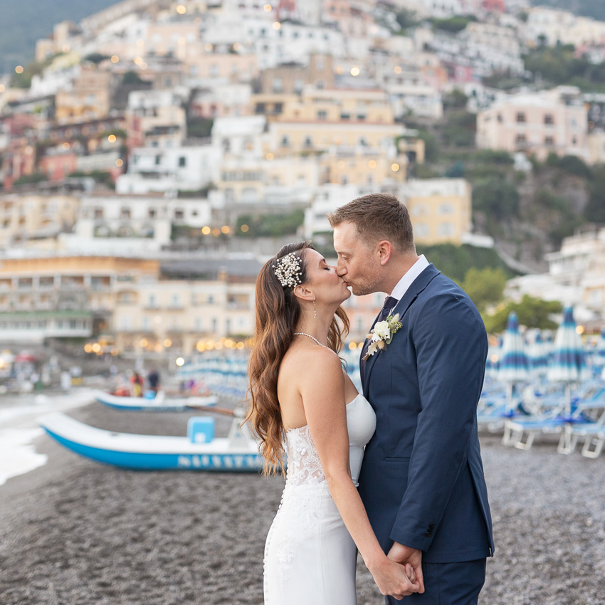 The couple kissing on the beach in Positano, Amalfi Coast