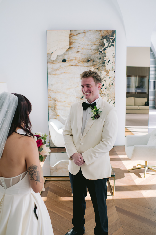 The groom see the bride for the first time with her dress