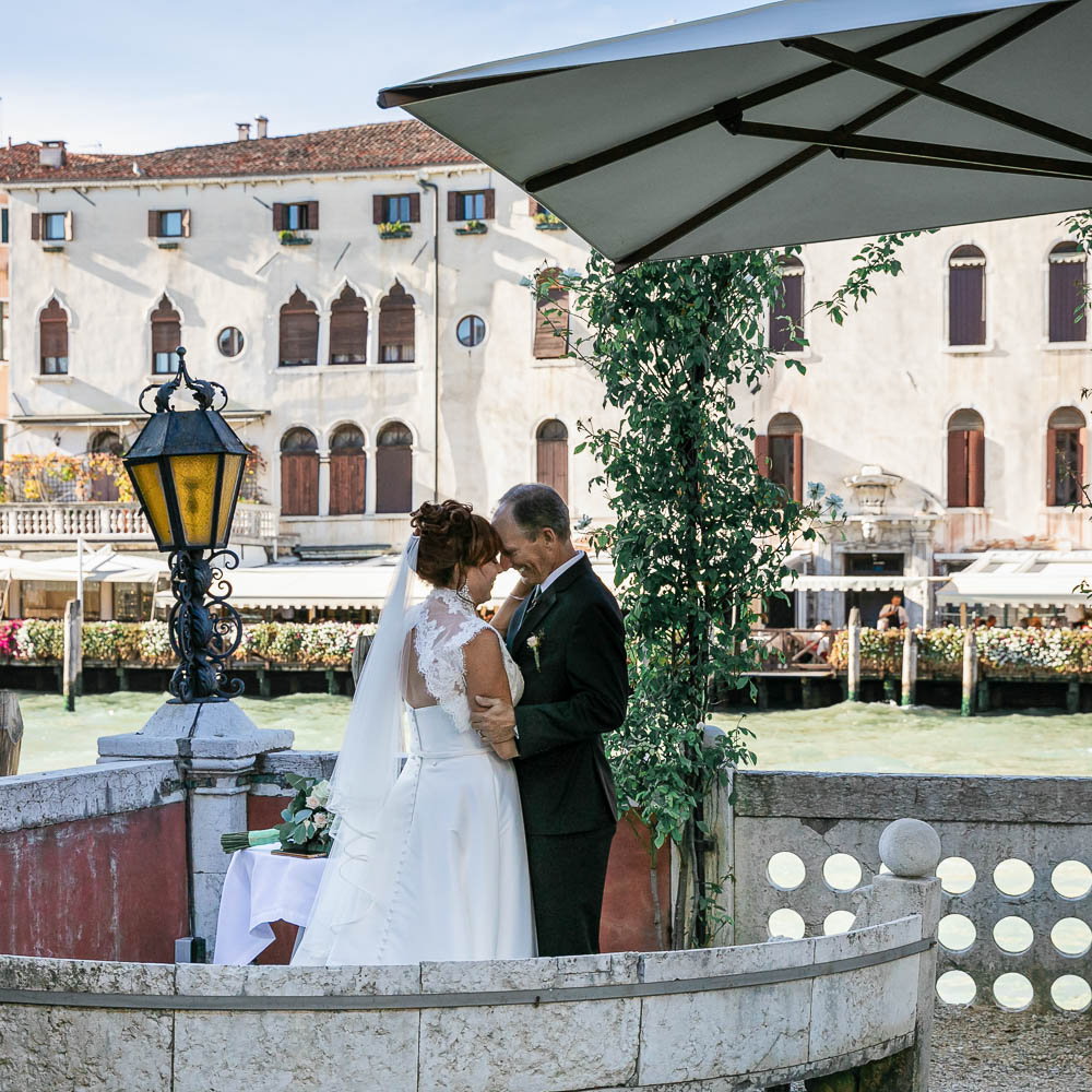 the couple overlooking the grand canal in venice from a private location