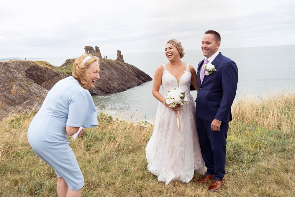 The mother of the groom reads her text and laugh