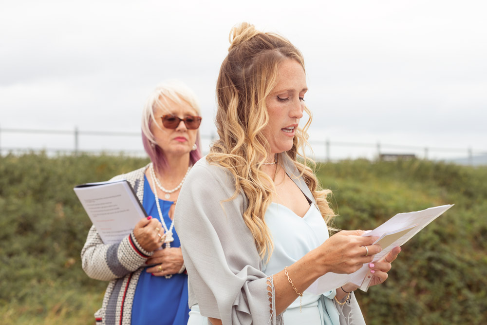 The bride sister and bridesmaid reads a text for the ceremony