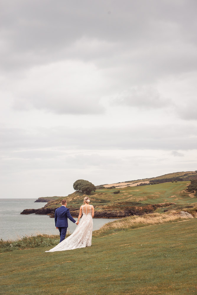 The bride and groom enjoying the moment after the ceremony for a walk along the cliff edge