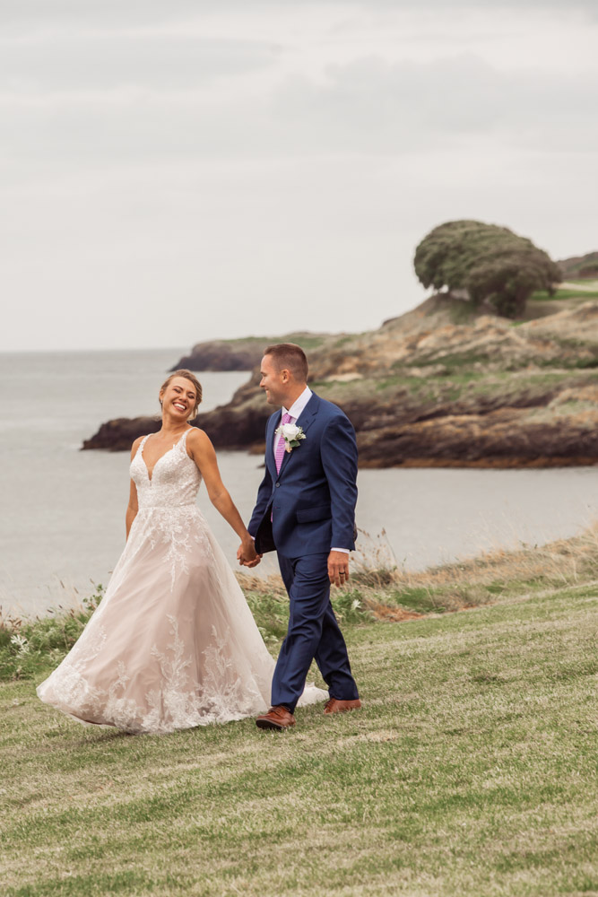 The couple walk on the cliff at Black castle, Ireland