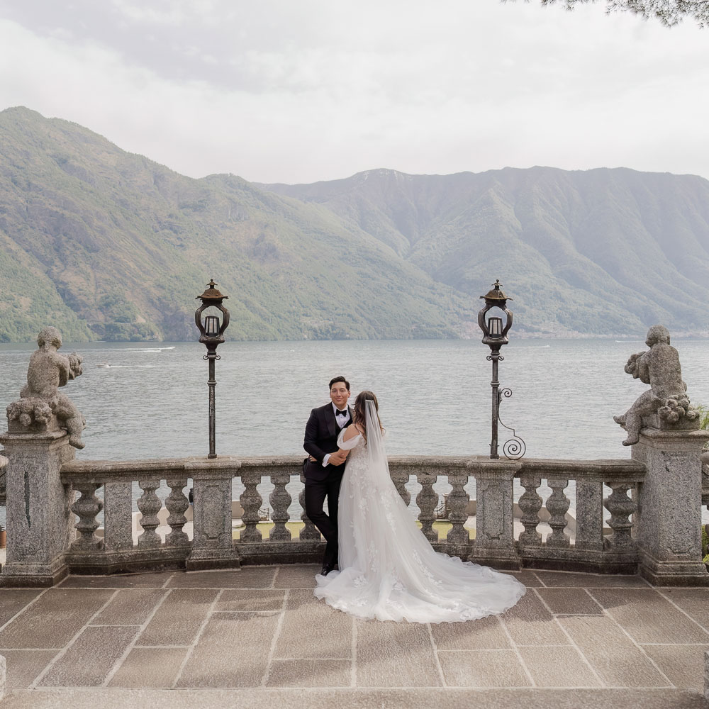 bride and groom posing at Lake como