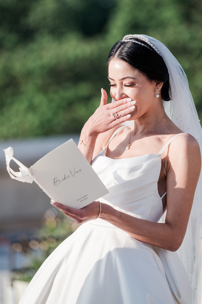 The bride laughs reading the vows