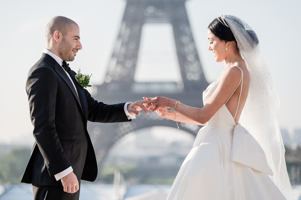 The bride slides the ring to the groom