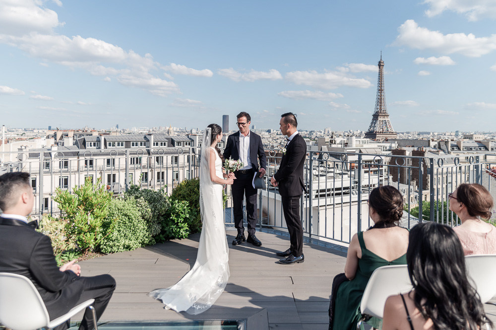 the celebrant starts the ceremony, we see the Eiffel tower in the background