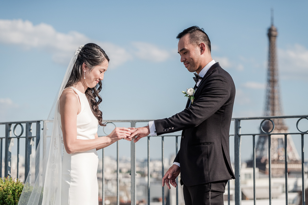 The bride slides the ring to the groom