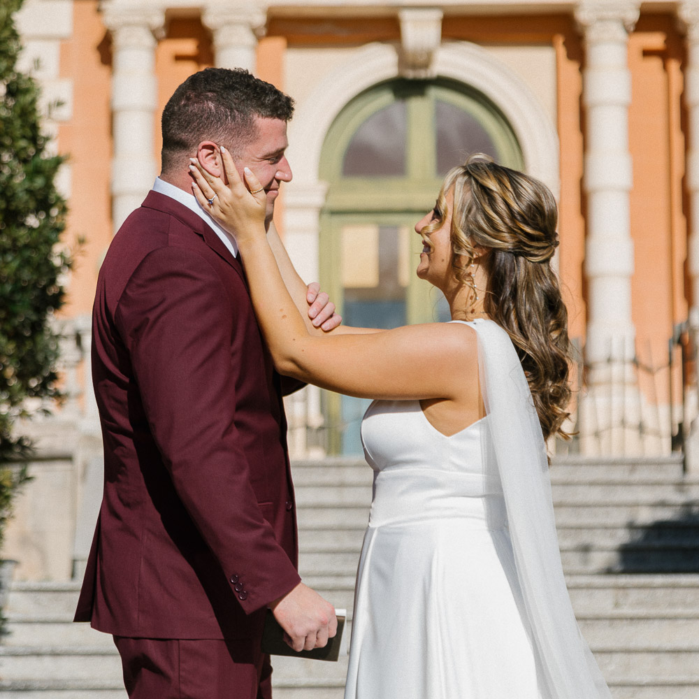 A gentle moment of emotion with the bride touching the face of th egroom