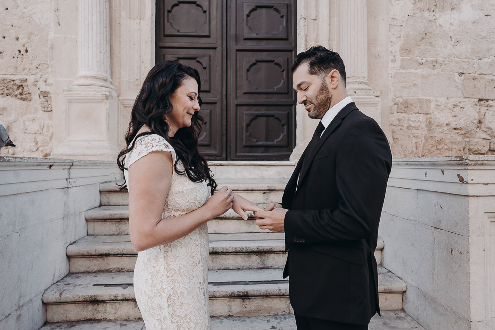 the groom slides the ring to the bride