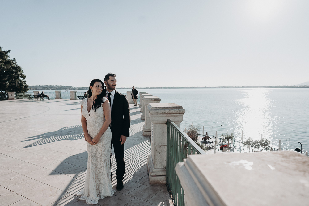 Right after the ceremony, the couple stands facing the see surrounded by the blue sky