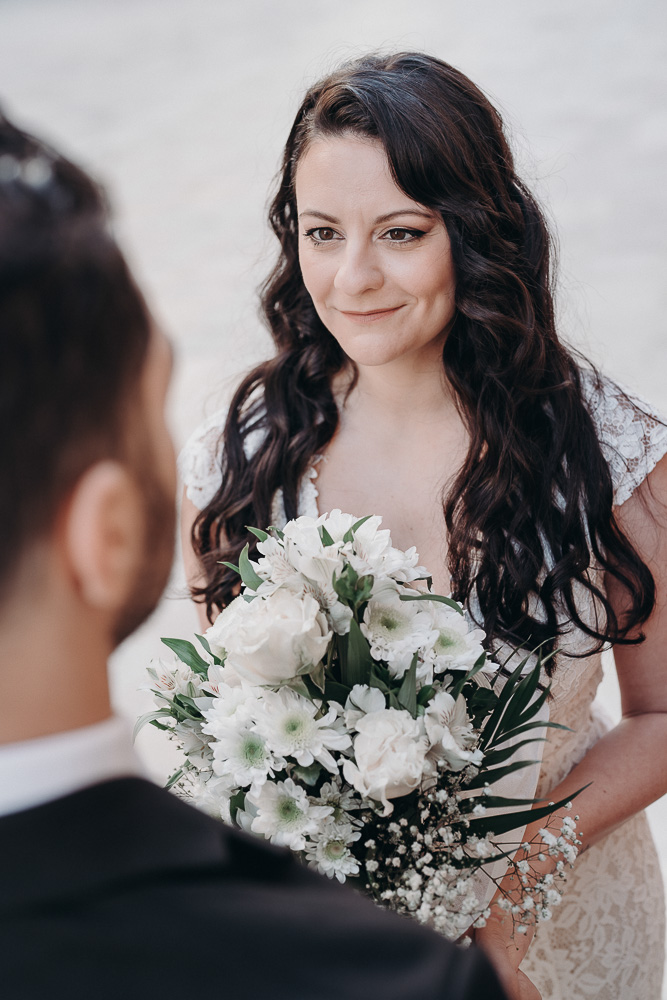 The brides looks to the groom during the vows