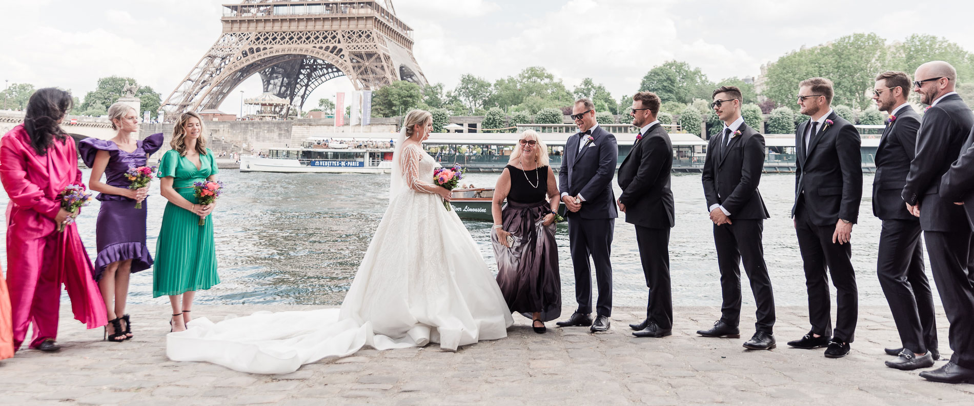 Family and guests during ceremony of a micro wedding, a setting in V shape to have the Eiffel in the background