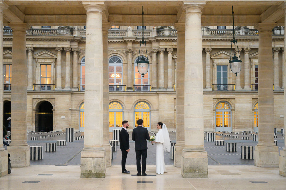 Bride and groom exchanging their rings at the bottom of the eiffel tower in Paris