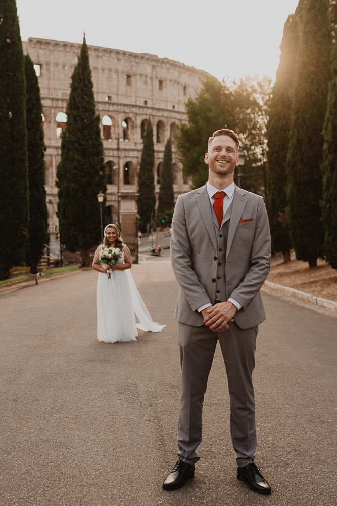 First look moment of an eloping couple with the majestic Colosseum in the background