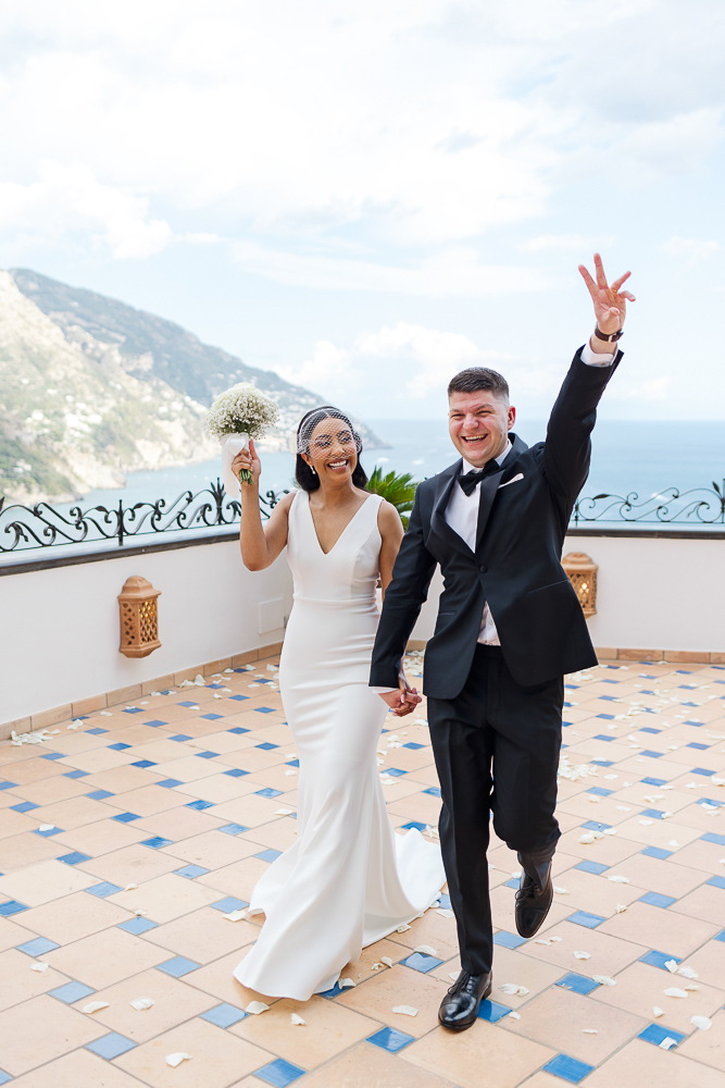 The bride and groom are married on the balcony over the village of Amalfi